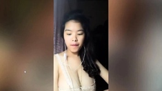 Vietnam brunette bares her big boobs to play with them