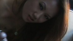 Slutty redheaded Asian broad shows how much she loves to suck penis
